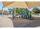 Shaded playground area with blue and green play equipment, slides, and climbing structures at 2629 E Verbena Dr, Phoenix, AZ 85048