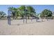 Inviting community playground featuring swings in a sand-covered play area with mature shade trees at 2629 E Verbena Dr, Phoenix, AZ 85048