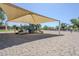 Community playground featuring a shaded play structure, swings, and slides in a sandy play area at 2629 E Verbena Dr, Phoenix, AZ 85048