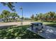 Community recreational area with a volleyball court, picnic tables, and green spaces for residents at 2629 E Verbena Dr, Phoenix, AZ 85048
