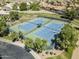 Aerial view of well-maintained community tennis courts surrounded by lush trees and green landscaping at 2629 E Verbena Dr, Phoenix, AZ 85048