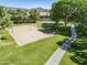 Outdoor sand volleyball court with well-maintained green space and nearby picnic tables for community recreation at 2629 E Verbena Dr, Phoenix, AZ 85048