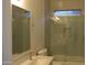 Well-lit bathroom featuring a glass-enclosed shower, modern fixtures, and stylish tiling at 29462 N 126Th Ln, Peoria, AZ 85383
