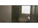 Bathroom featuring a tiled shower with glass door, block window, and large soaking tub at 29462 N 126Th Ln, Peoria, AZ 85383