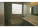 Updated bathroom featuring block window, soaking tub, tiled shower, and double sink vanity at 29462 N 126Th Ln, Peoria, AZ 85383