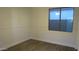 Clean, minimalist bedroom with hard wood floors and a bright window at 29462 N 126Th Ln, Peoria, AZ 85383
