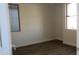 A bedroom view with plank flooring, neutral colored walls, a ceiling fan and two windows at 29462 N 126Th Ln, Peoria, AZ 85383