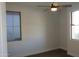 This spacious bedroom features a ceiling fan, neutral walls, and plank flooring at 29462 N 126Th Ln, Peoria, AZ 85383