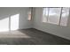 Bright bedroom featuring wood-look floors and sunny windows at 29462 N 126Th Ln, Peoria, AZ 85383