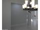 A stylish chandelier in a dining space with views into adjacent rooms at 29462 N 126Th Ln, Peoria, AZ 85383