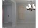 Formal dining area showcasing a decorative chandelier, large window and entry door at 29462 N 126Th Ln, Peoria, AZ 85383