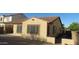 Exterior home view highlighting the side facade, windows, and brick-paved yard at 29462 N 126Th Ln, Peoria, AZ 85383