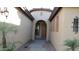 Charming front entrance with an arched entryway and lush landscaping at 29462 N 126Th Ln, Peoria, AZ 85383