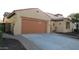Inviting front exterior with a beautiful front door, garage and well-manicured landscaping at 29462 N 126Th Ln, Peoria, AZ 85383
