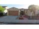 Inviting front exterior with a beautiful front door, garage and well-manicured landscaping at 29462 N 126Th Ln, Peoria, AZ 85383