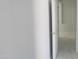 Hallway featuring tile flooring with white doors at 29462 N 126Th Ln, Peoria, AZ 85383