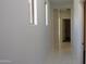 Bright hallway with marble style tile floors and two windows at 29462 N 126Th Ln, Peoria, AZ 85383