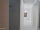 Hallway with a neutral color scheme and a bright view from an end window at 29462 N 126Th Ln, Peoria, AZ 85383