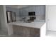 Well-lit kitchen features stainless steel appliances, a large island, and sleek countertops at 29462 N 126Th Ln, Peoria, AZ 85383