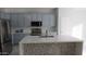 Bright kitchen features stainless steel appliances, a large island, and sleek countertops at 29462 N 126Th Ln, Peoria, AZ 85383