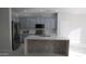 Modern kitchen features stainless steel appliances, stylish backsplash, and a spacious island with tiled accents at 29462 N 126Th Ln, Peoria, AZ 85383