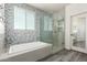 Elegant bathroom with a soaking tub, glass-enclosed shower, and stylish tile accents at 32525 N 41St Way, Cave Creek, AZ 85331