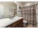 Cozy bathroom with a single sink vanity, decorative mirror, and a shower-tub combo at 32525 N 41St Way, Cave Creek, AZ 85331