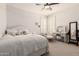 Bright bedroom with white walls, multiple windows with shutters, and charming furniture with a mirror at 32525 N 41St Way, Cave Creek, AZ 85331