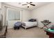 Bright bedroom with a twin bed, desk, and ample natural light from the large window at 32525 N 41St Way, Cave Creek, AZ 85331