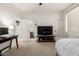Well-lit bedroom featuring a bed, work space, and ensuite bathroom access at 32525 N 41St Way, Cave Creek, AZ 85331