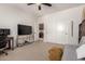 Well-lit bedroom includes a desk, TV, large closet, and entry to an ensuite bath at 32525 N 41St Way, Cave Creek, AZ 85331