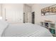 Bedroom features neutral walls, striped bedding, a built-in closet, and modern decor for storage at 32525 N 41St Way, Cave Creek, AZ 85331