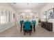 A bright dining room featuring a chandelier, wainscoting, and a formal table set for dinner at 32525 N 41St Way, Cave Creek, AZ 85331