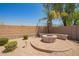 Inviting outdoor fire pit area with stone seating and a tranquil garden setting at 32525 N 41St Way, Cave Creek, AZ 85331