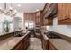 A kitchen showcases wood cabinets, granite countertops, stainless appliances, and gas cooktop on the counter at 32525 N 41St Way, Cave Creek, AZ 85331