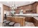 Beautiful kitchen featuring wood cabinets, stainless steel appliances, granite countertops, and an island with seating at 32525 N 41St Way, Cave Creek, AZ 85331