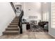 A nicely decorated living room and stairway with large windows providing natural light at 32525 N 41St Way, Cave Creek, AZ 85331