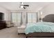 Spacious main bedroom featuring a ceiling fan, sitting area, and a neutral color palette at 32525 N 41St Way, Cave Creek, AZ 85331