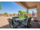 Inviting covered patio with stylish outdoor seating overlooking the landscaped backyard with pool at 32525 N 41St Way, Cave Creek, AZ 85331