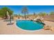 Backyard pool with desert landscaping, brick patio, and slide feature for recreational enjoyment at 32525 N 41St Way, Cave Creek, AZ 85331