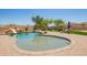 Sparkling pool featuring a rock slide, surrounded by a brick patio and lush landscaping at 32525 N 41St Way, Cave Creek, AZ 85331