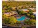 Beautiful aerial view of community with resort-style pool nestled among lush greenery and scenic mountain backdrop at 36601 N Mule Train Rd # 45B, Carefree, AZ 85377