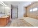 Spacious primary bathroom featuring double sinks, a soaking tub, and a separate walk-in shower for a spa-like experience at 36601 N Mule Train Rd # 45B, Carefree, AZ 85377