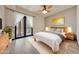 Bright bedroom features a king bed, wood floors, ceiling fan and french doors leading to a private outdoor space at 36601 N Mule Train Rd # 45B, Carefree, AZ 85377