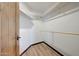 Walk-in closet with wood laminate floors offers plenty of storage and organization space in this convenient layout at 36601 N Mule Train Rd # 45B, Carefree, AZ 85377