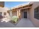 Inviting courtyard entry with desert landscaping and stone accents and covered area providing a private outdoor space at 36601 N Mule Train Rd # 45B, Carefree, AZ 85377