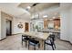 Open dining area connects to a chef's kitchen, featuring modern lighting and skylights at 36601 N Mule Train Rd # 45B, Carefree, AZ 85377