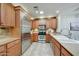 Well-equipped kitchen boasts stainless steel appliances, granite countertops, and custom cabinetry at 36601 N Mule Train Rd # 45B, Carefree, AZ 85377