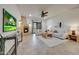 Comfortable living room with a fireplace, ceiling fan, media center, and patio access at 36601 N Mule Train Rd # 45B, Carefree, AZ 85377