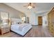 Large main bedroom features wood floors, ample natural light, and a ceiling fan at 36601 N Mule Train Rd # 45B, Carefree, AZ 85377